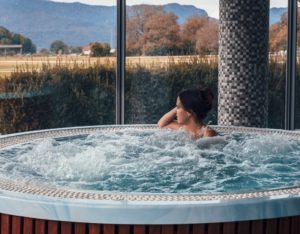 woman looking at nature while sitting in a hot tub