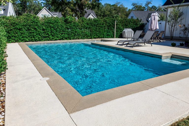 Geometric pool with black sun loungers - Pools By York