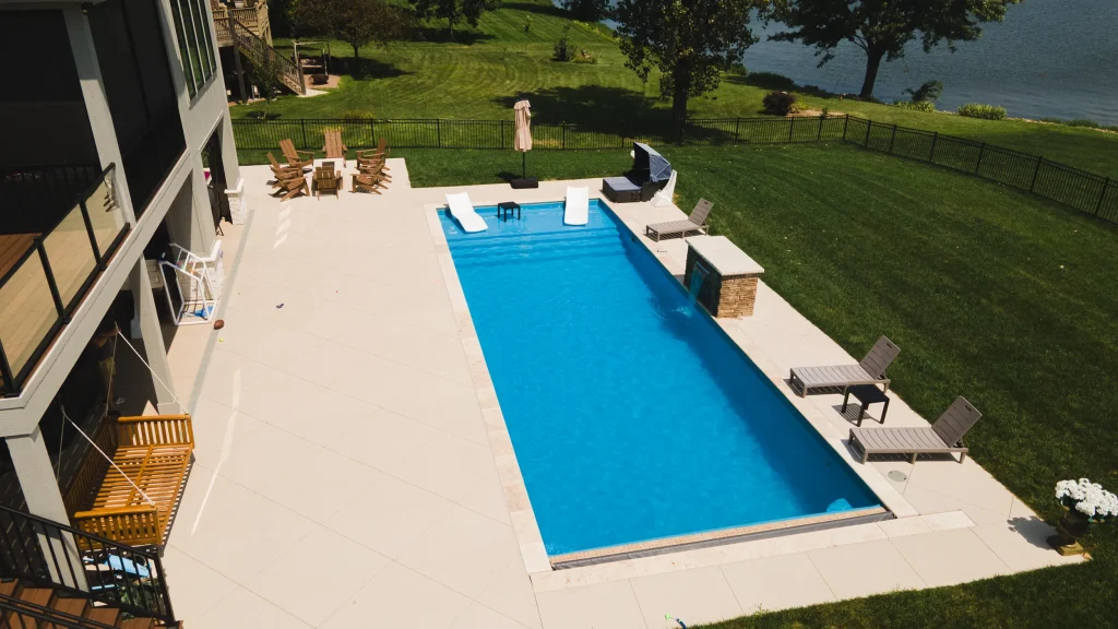 Elevated view of a rectangular fiberglass pool overlooking a lake