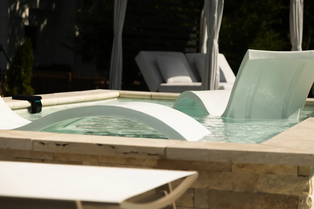 In-pool loungers on a fiberglass pool tanning ledge